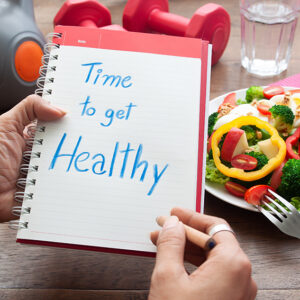 Time to get healthy, text on diary book with salad and fitness i